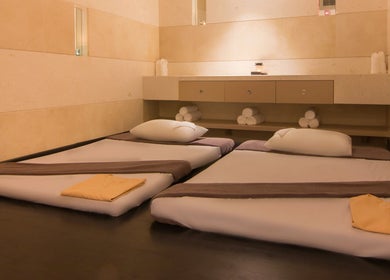 Tranquil spa room at The Spa at Sun and Moon Urban, Phnom Penh, Phnom Penh, KH, featuring two massage beds.