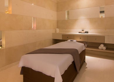 Tranquil massage room at The Spa at Sun and Moon Urban, Phnom Penh, Phnom Penh, KH, featuring a cozy ambiance.