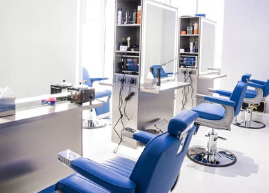 Chic interior of Back Alive Barbershop | Marina in دبي, دبي, AE with sleek barber chairs and mirrors.