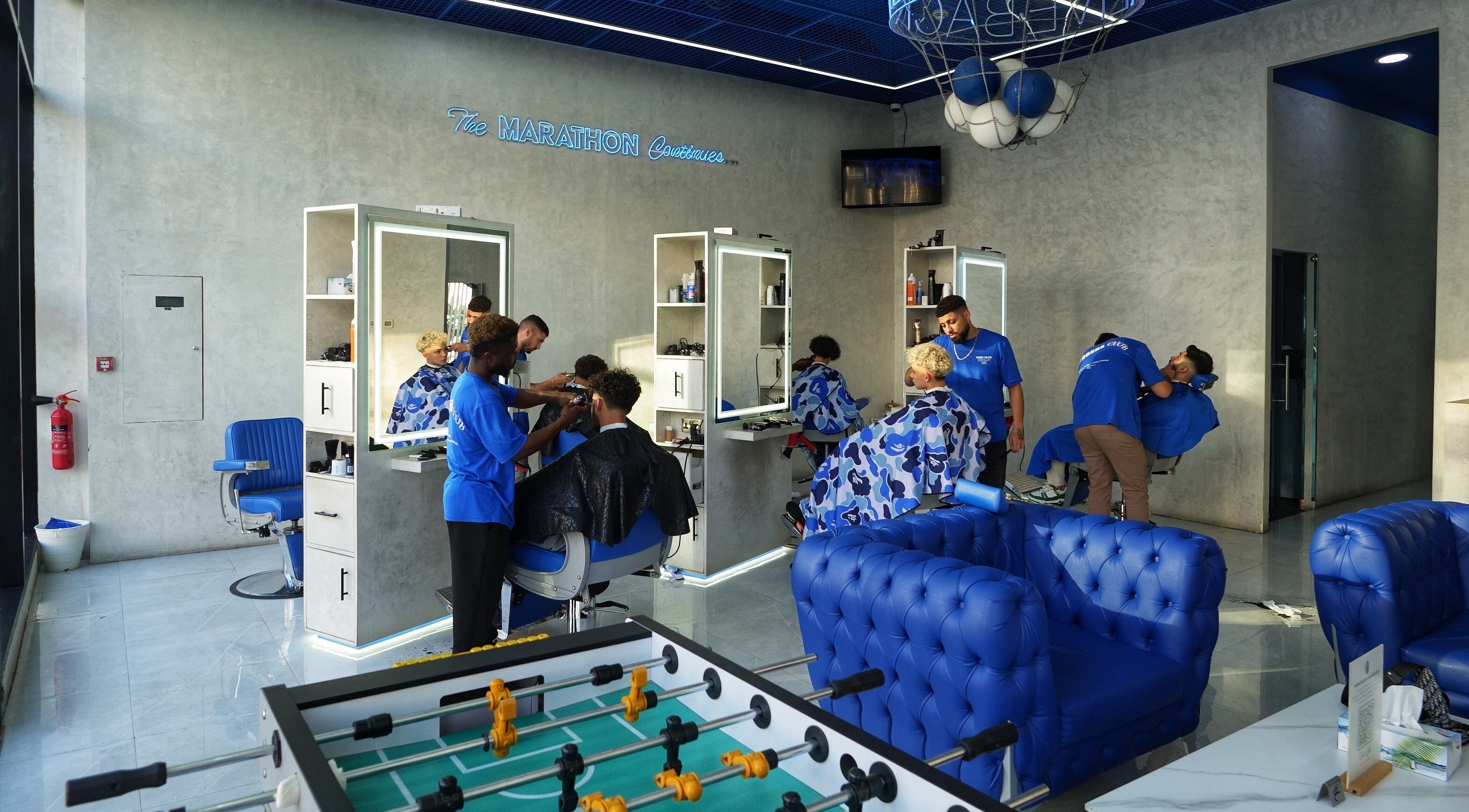 Stylish interior of Back Alive Barbershop at City Walk, Dubai, Dubai, AE showing haircuts in progress.