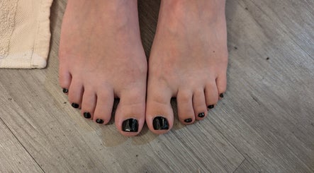 Close-up of freshly polished black toenails at JC Relaxation and Beauty (Above TFC Gym), Sheffield, England, GB.