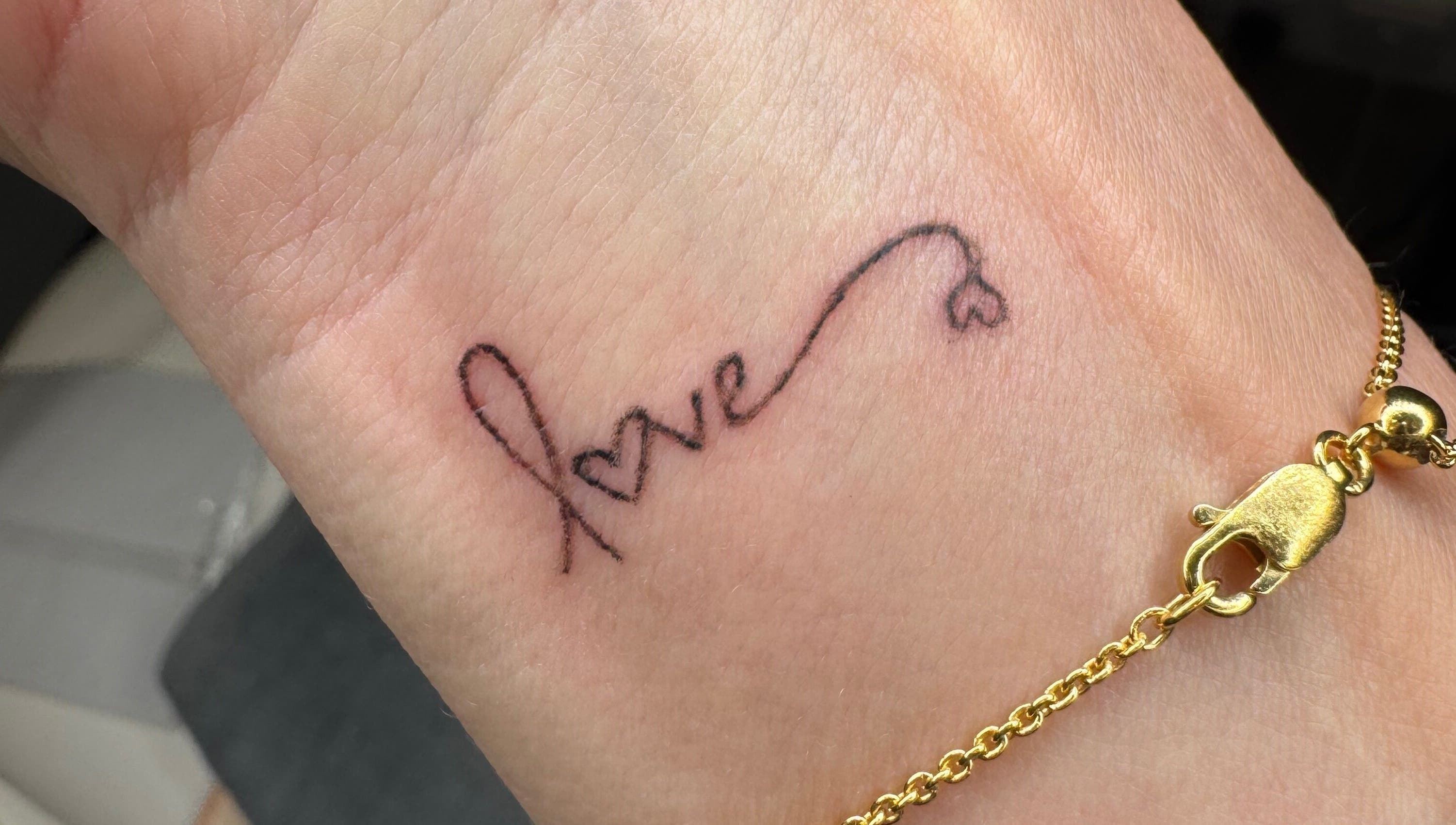 Delicate 'love' tattoo on wrist by Tiffany MacDonald - Permanent Make-Up - Scalp SMP - Fine Line Tattoo, Weybridge, England, GB.