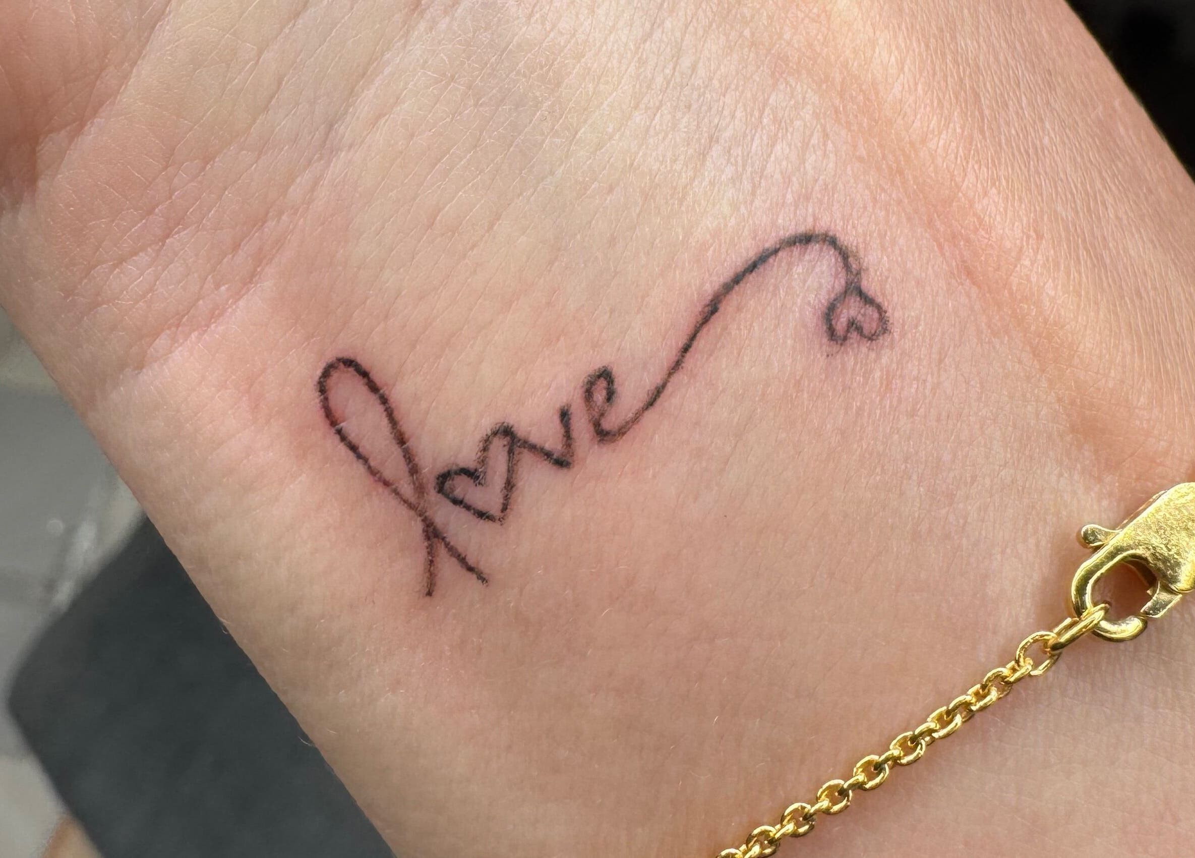 Delicate 'love' tattoo on wrist by Tiffany MacDonald - Permanent Make-Up - Scalp SMP - Fine Line Tattoo, Weybridge, England, GB.