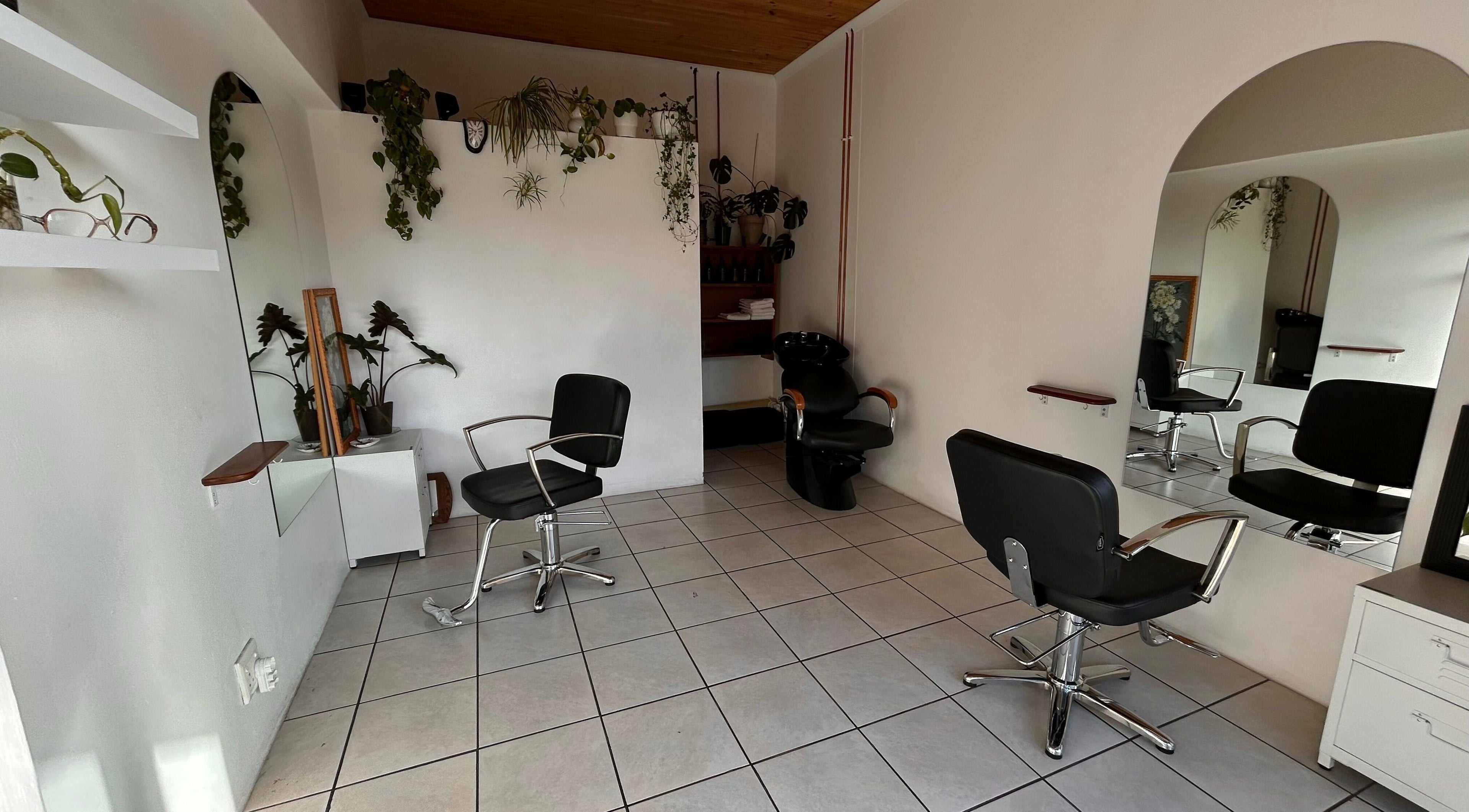 Modern salon chairs and mirrors at Flowers Hair Studio, Cape Town, Western Cape, ZA.