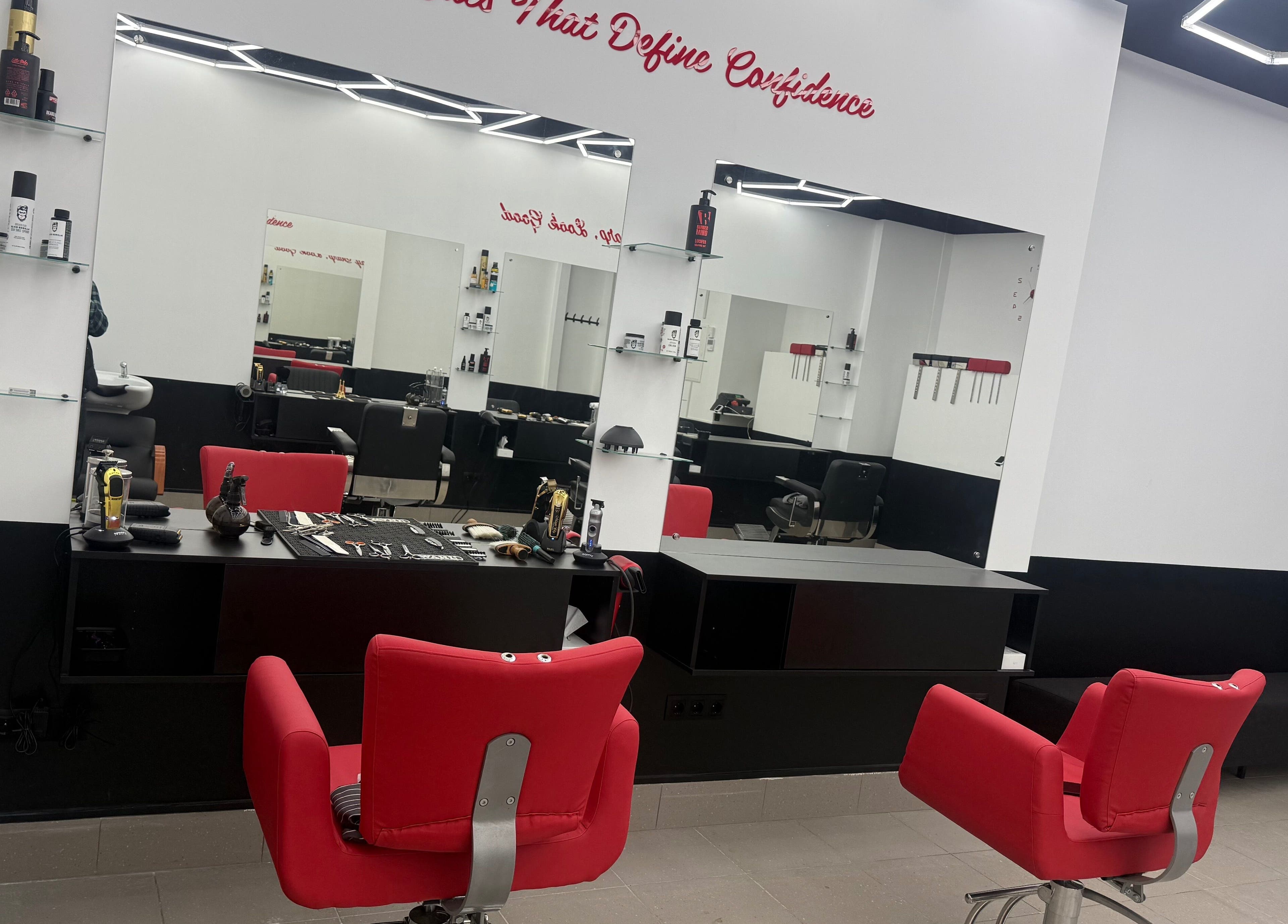 Sleek salon interior with red chairs at Desi (Āgenskalna Tirgus), Rīga, LV, featuring modern design.