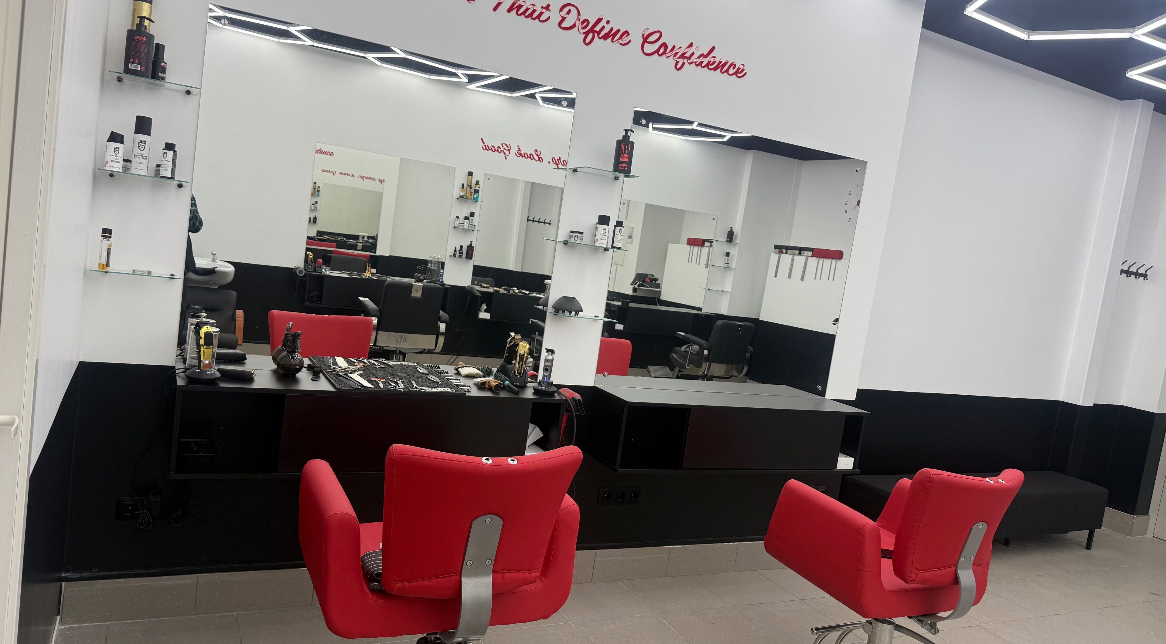 Sleek salon interior with red chairs at Desi (Āgenskalna Tirgus), Rīga, LV, featuring modern design.