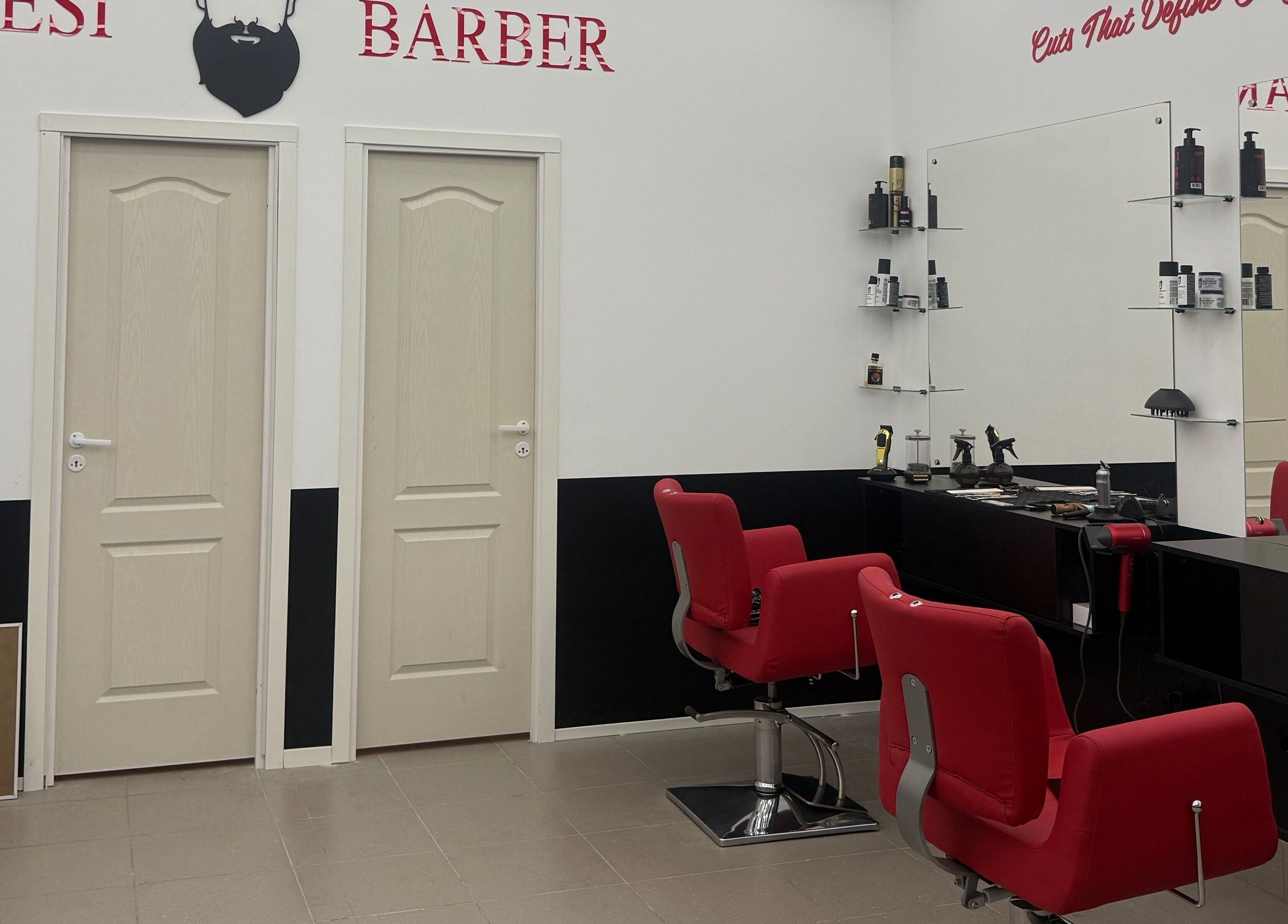Modern barber interior at Desi (Āgenskalna Tirgus) with red chairs and mirrors in Rīga, LV.