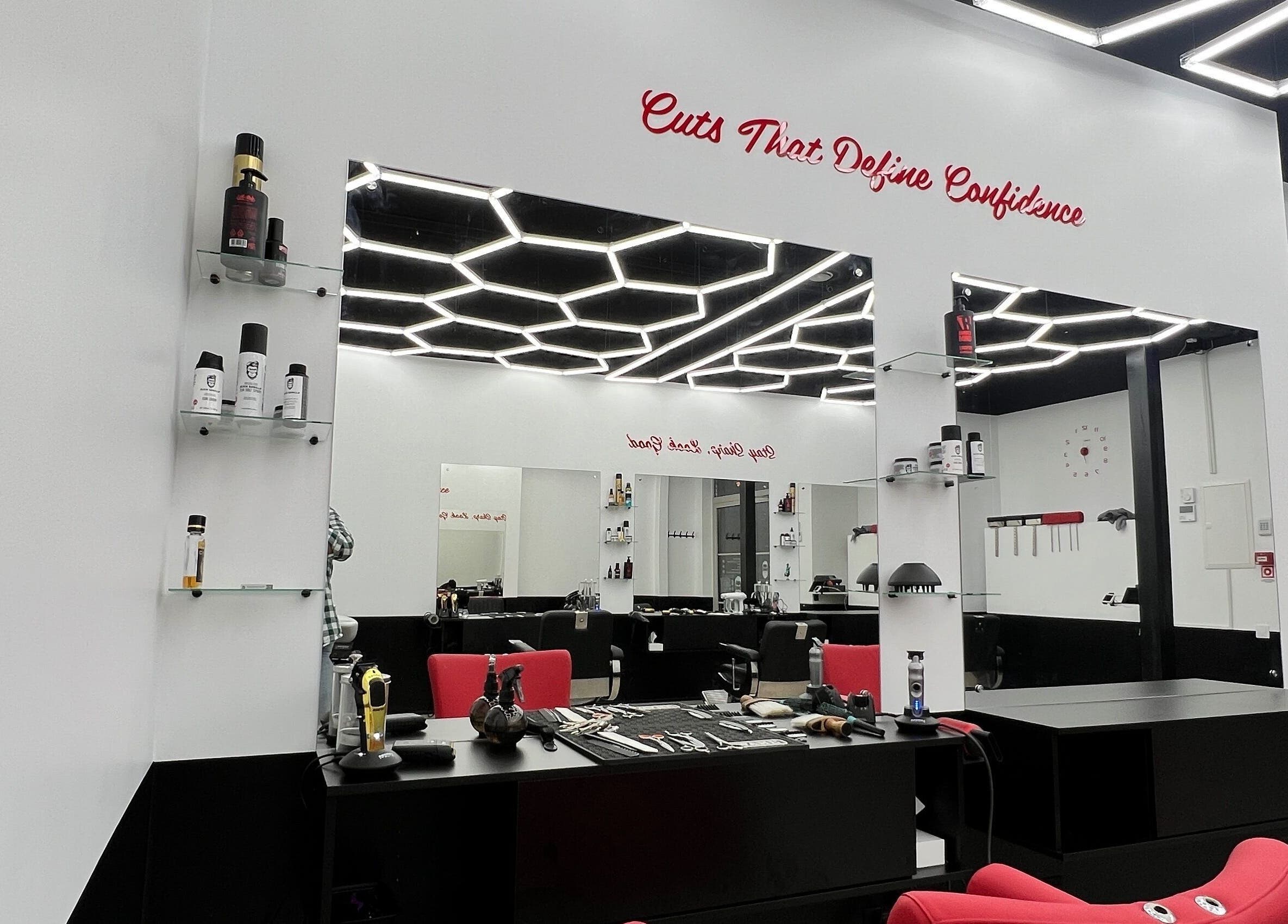 Modern salon interior at Desi (Āgenskalna Tirgus), Rīga, LV. Sleek design with red chairs and product displays.