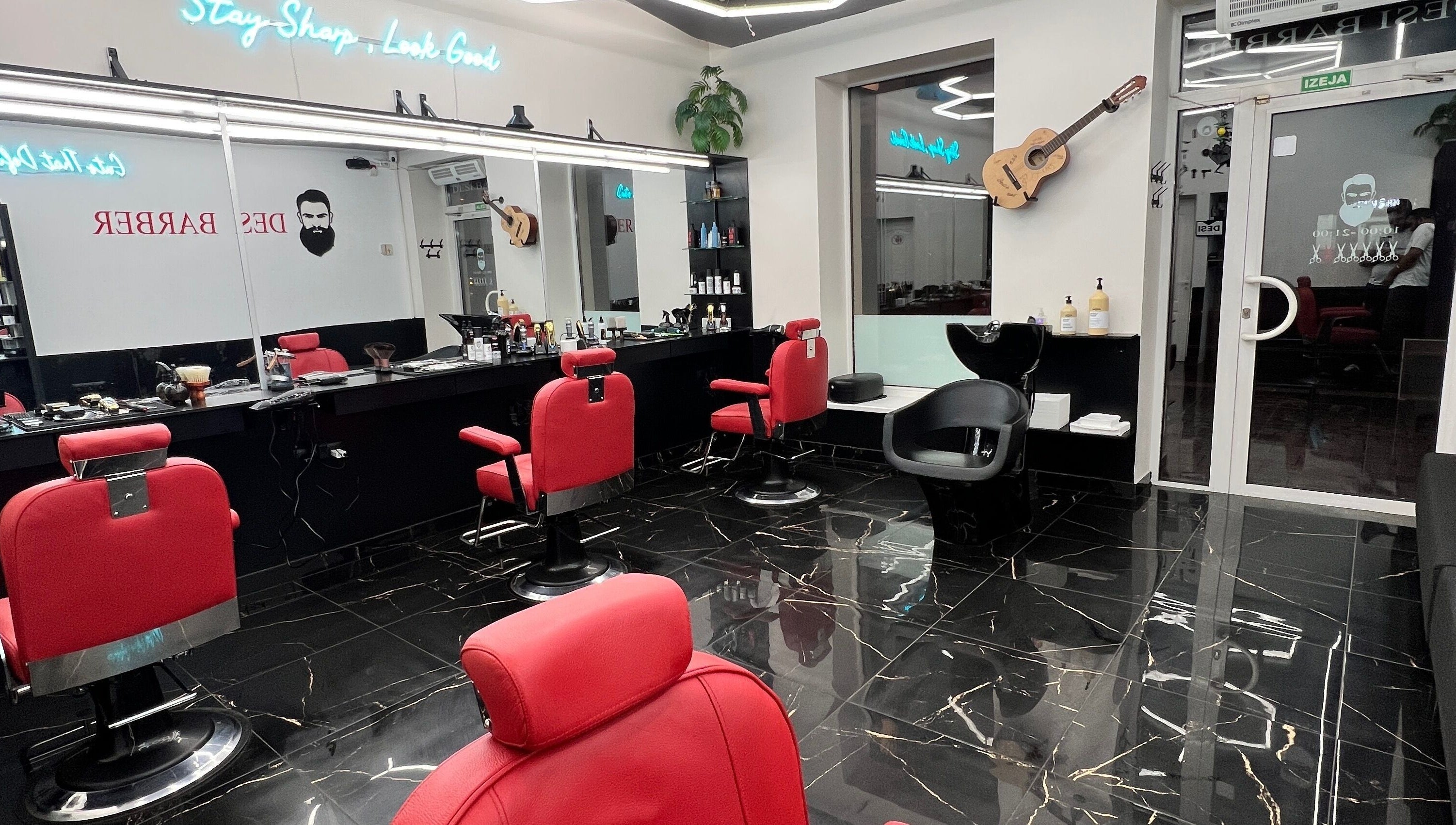 Luxurious barber chairs in Desi (Aleksandra Caka), Rīga, LV, offering sleek grooming services.