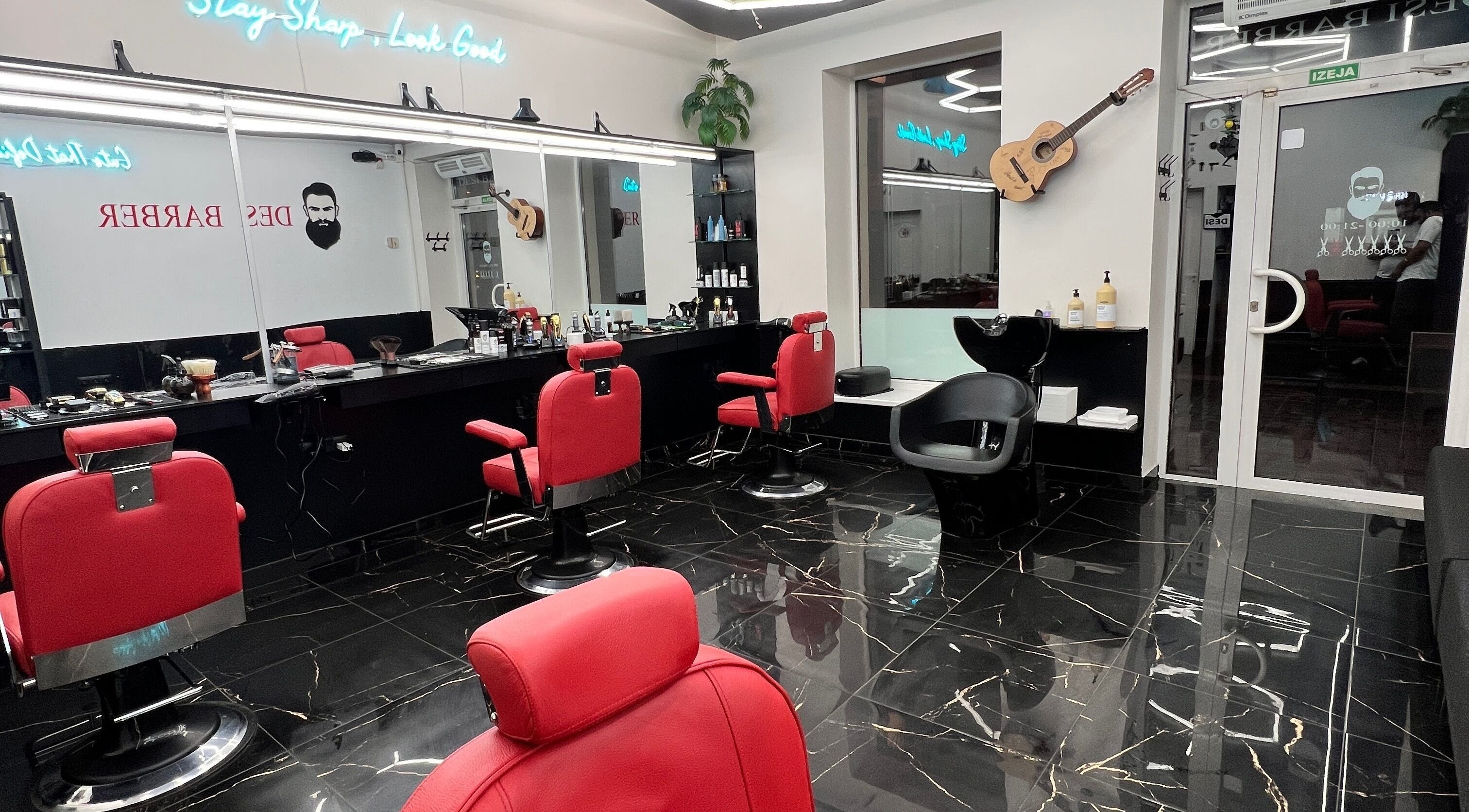 Luxurious barber chairs in Desi (Aleksandra Caka), Rīga, LV, offering sleek grooming services.