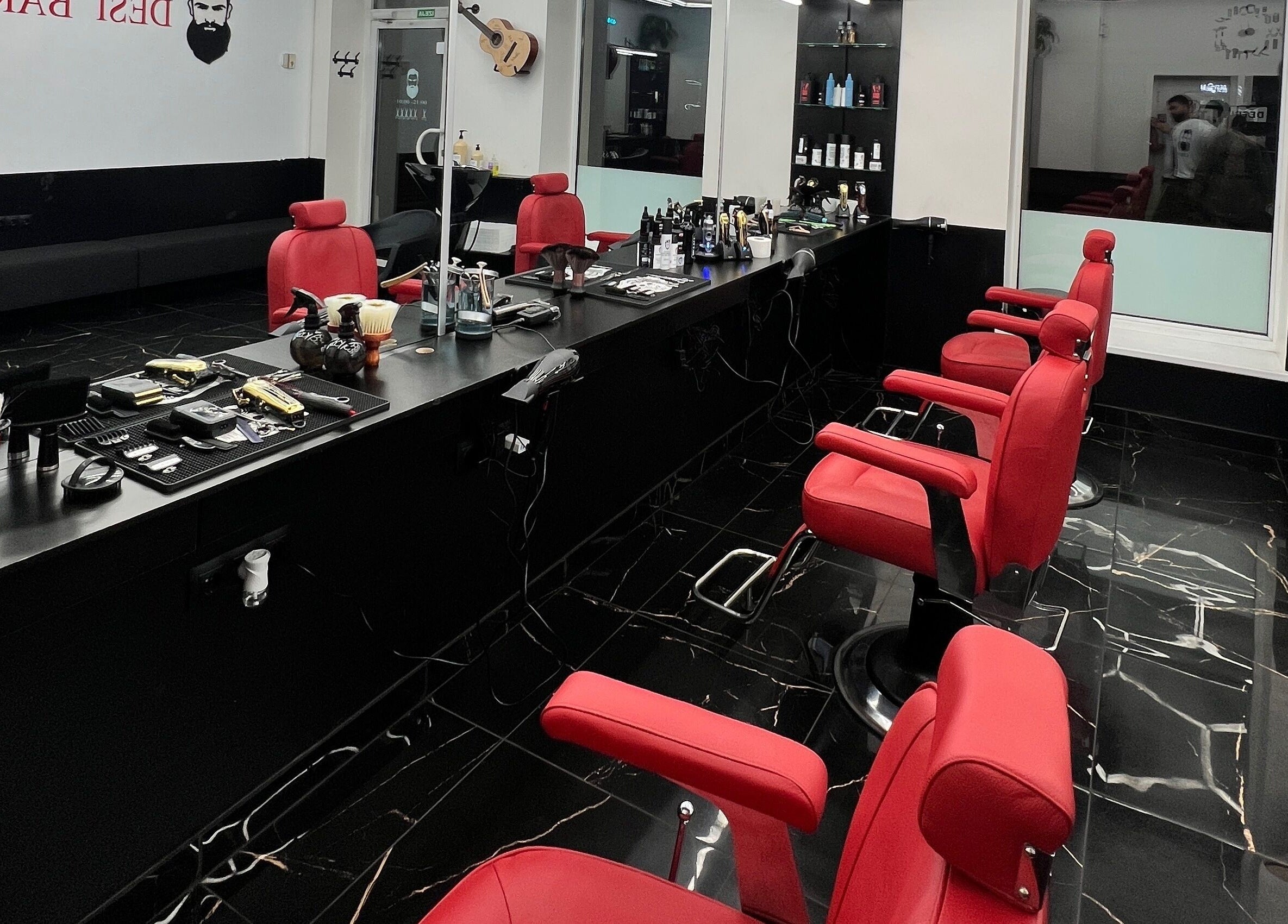 Elegant salon setup with red chairs at Desi (Aleksandra Caka), Rīga, LV.