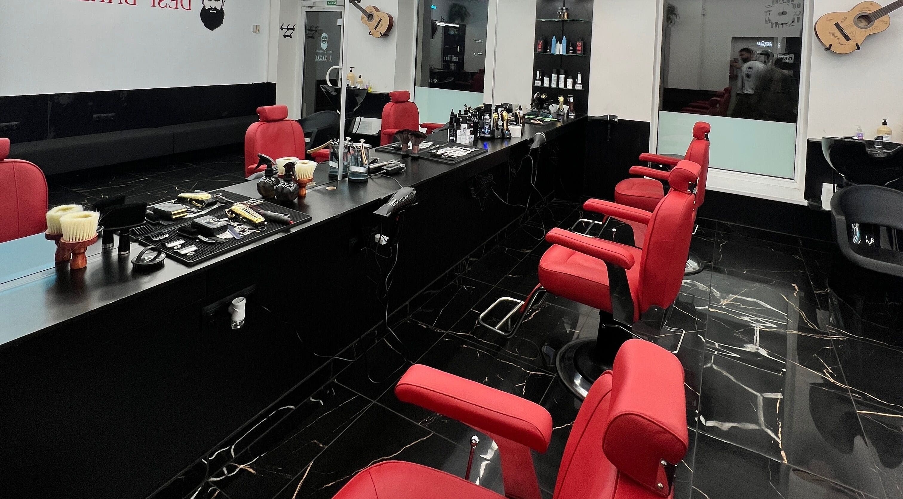 Elegant salon setup with red chairs at Desi (Aleksandra Caka), Rīga, LV.