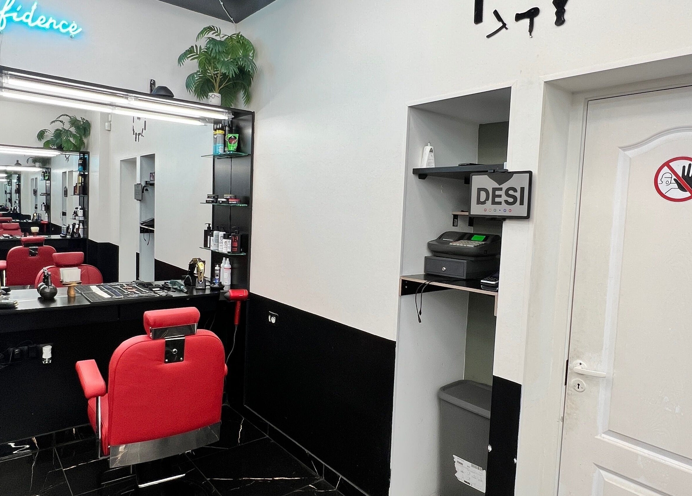 Desi (Aleksandra Caka), Rīga, LV: Modern red chairs and sleek mirrors in stylish salon.