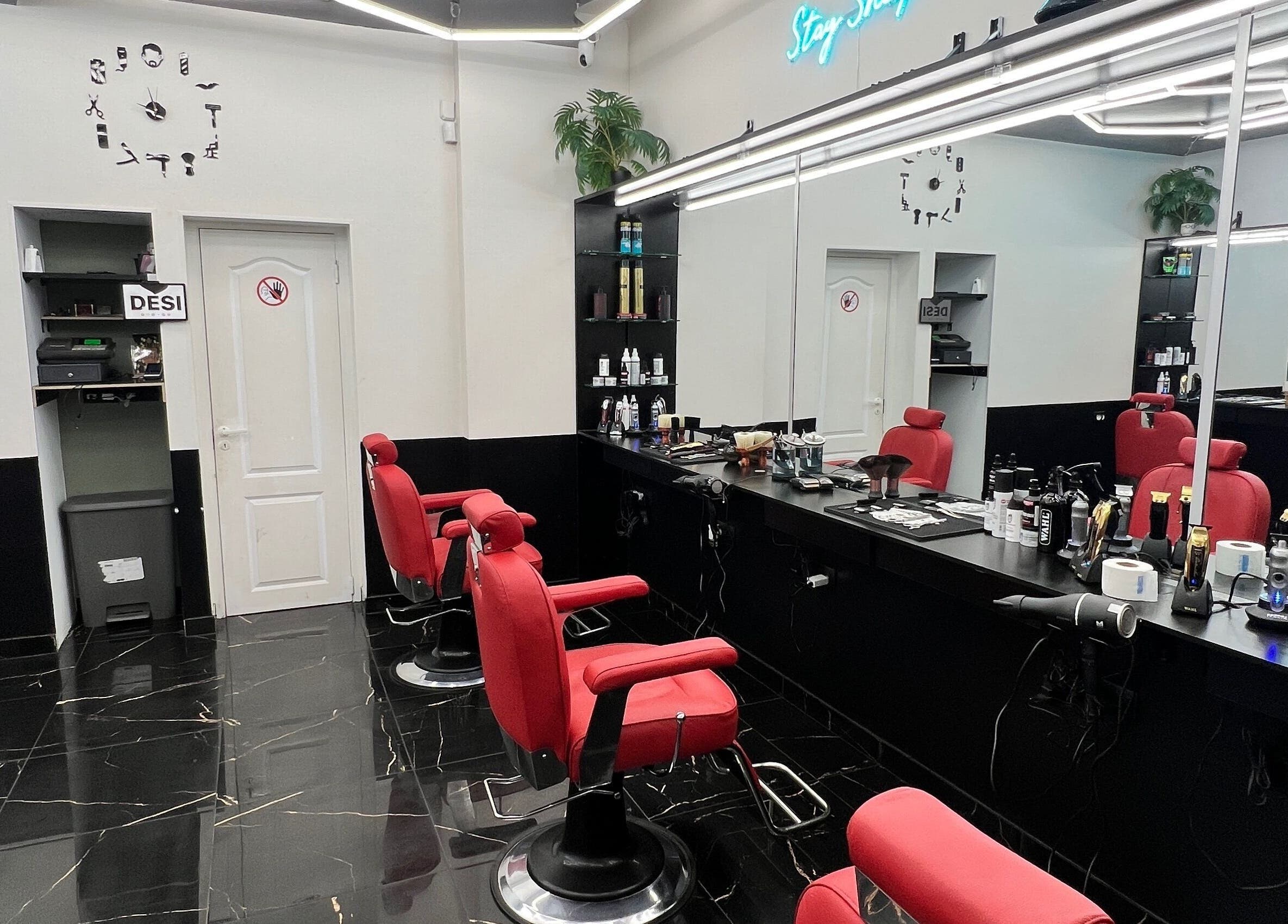 Modern salon interior with red chairs at Desi (Aleksandra Caka), Rīga, LV.