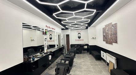 Modern barber shop at Desi (Brivibas Iela) in Rīga, LV with stylish hexagon lighting and sleek interior design.