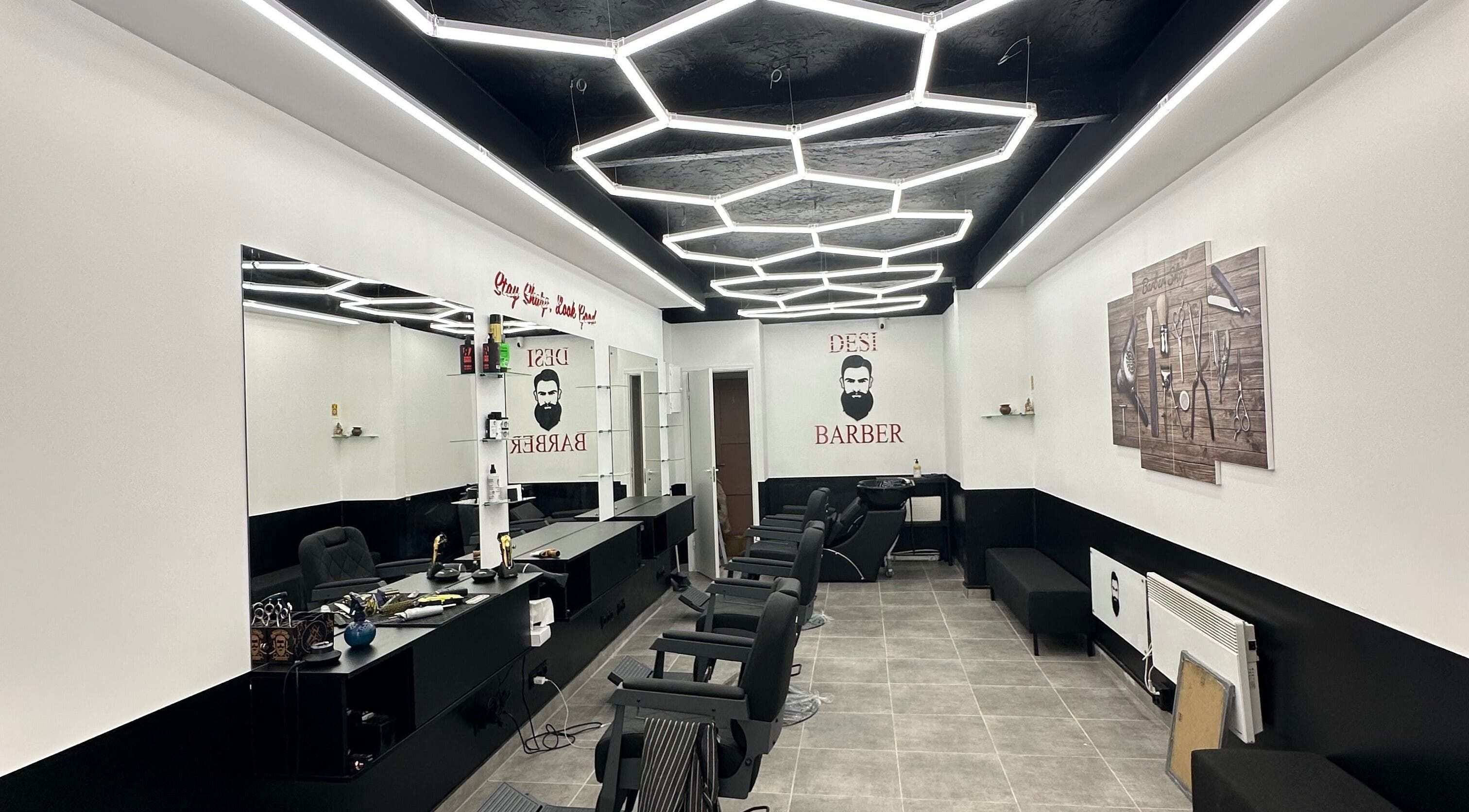 Modern barber shop at Desi (Brivibas Iela) in Rīga, LV with stylish hexagon lighting and sleek interior design.