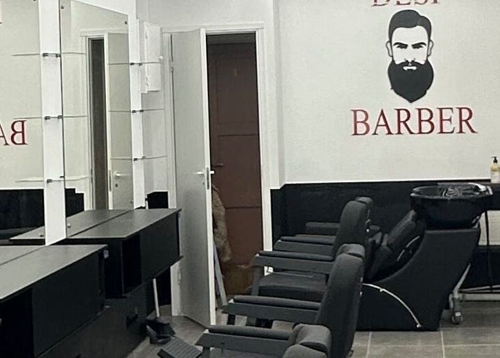 Modern barber interior at Desi (Brivibas Iela), Rīga, LV, featuring sleek black styling chairs.