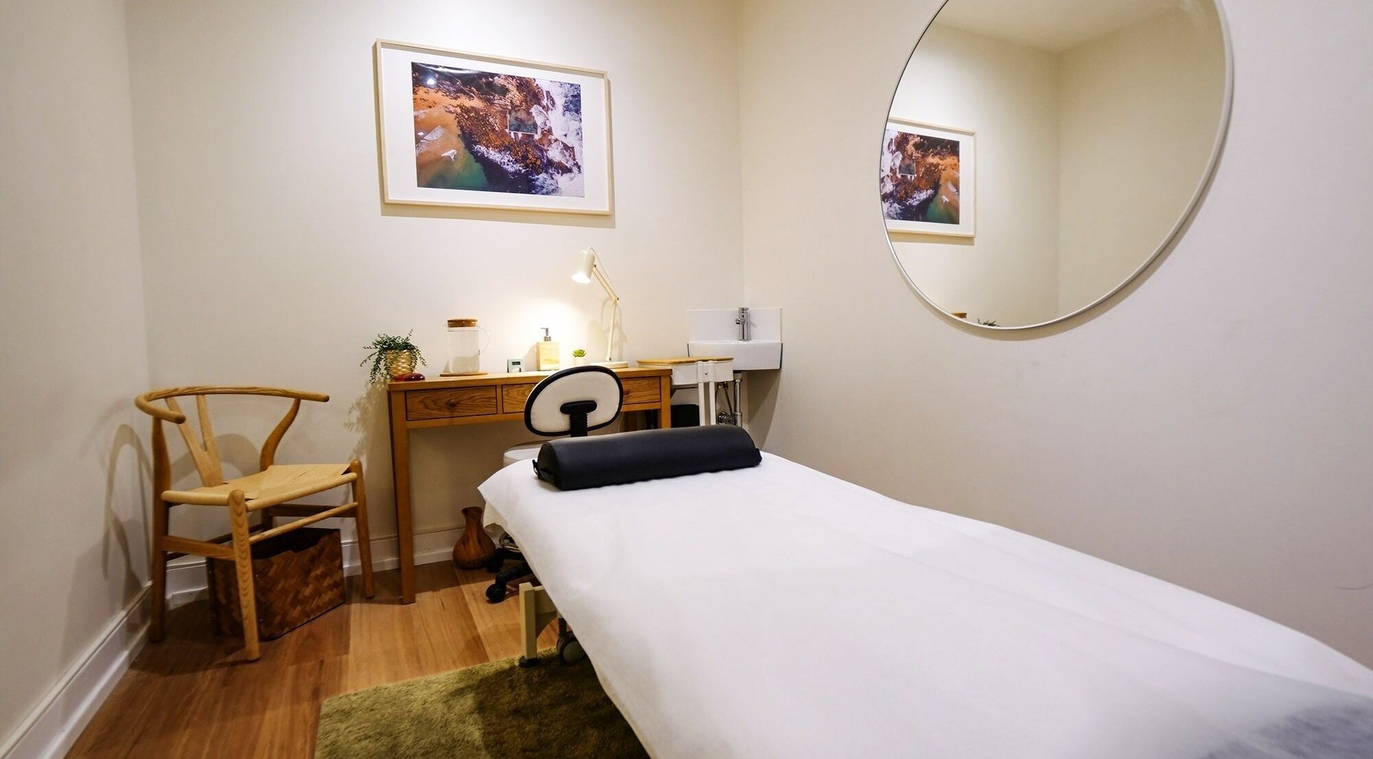 Calm treatment room at Akasha Integrative Health, Manly, New South Wales, AU with a massage table and decor.