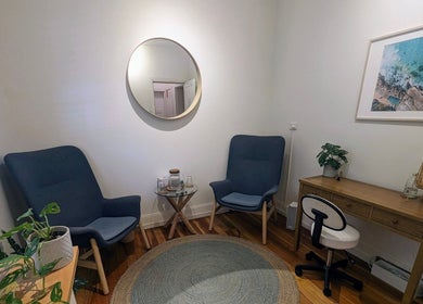 Peaceful room at Akasha Integrative Health, Manly, New South Wales, AU, with chairs, plants, and a desk.