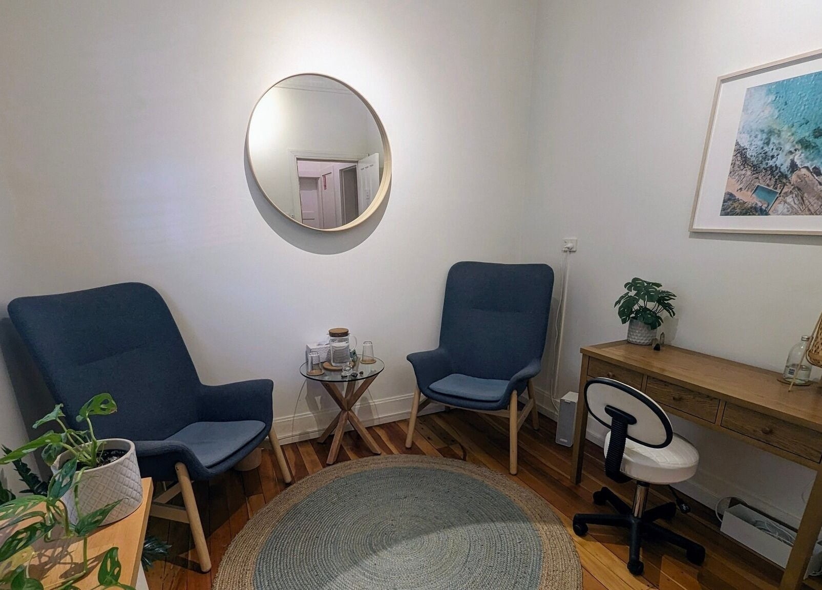 Peaceful room at Akasha Integrative Health, Manly, New South Wales, AU, with chairs, plants, and a desk.
