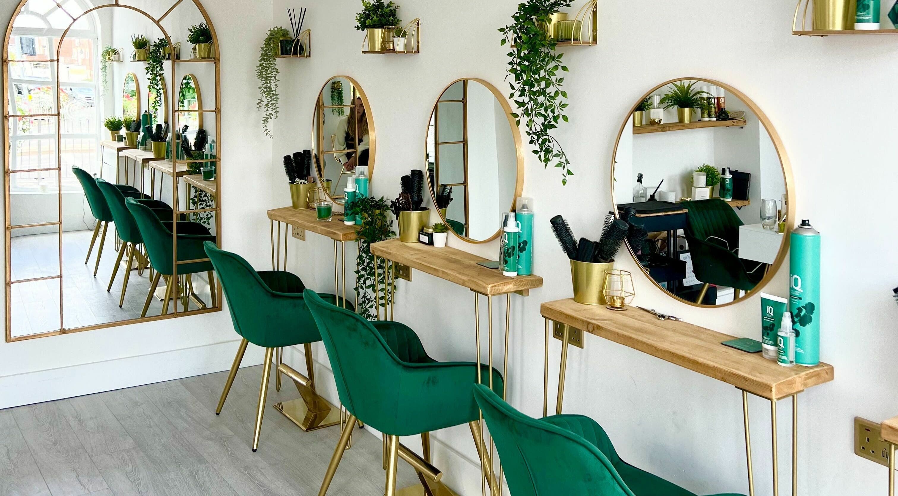Chic salon interior with green chairs and mirrors at Studio 66, Broxbourne, England, GB.