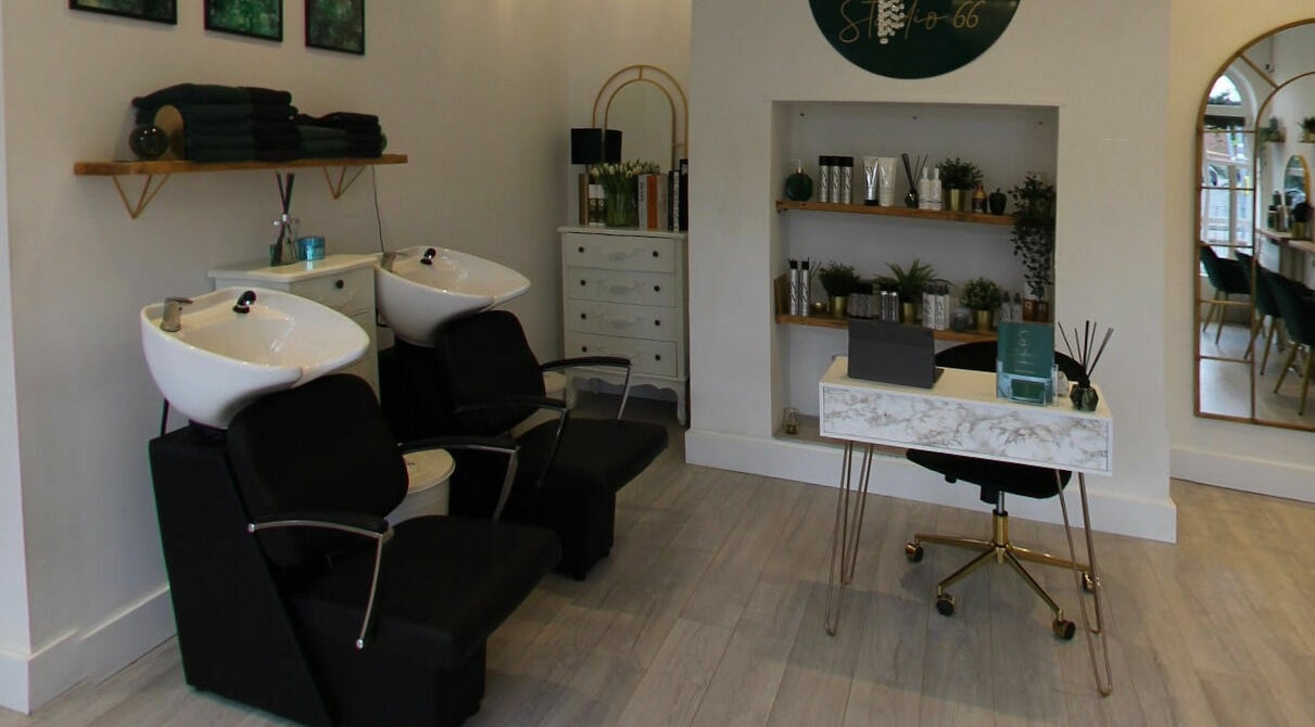 Elegant interior of Studio 66 in Broxbourne, England, featuring hair wash stations and a stylish decor.