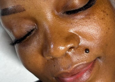 Relaxed woman with glowing skin at Hunny's Clinique, Rustenburg, North West, ZA.