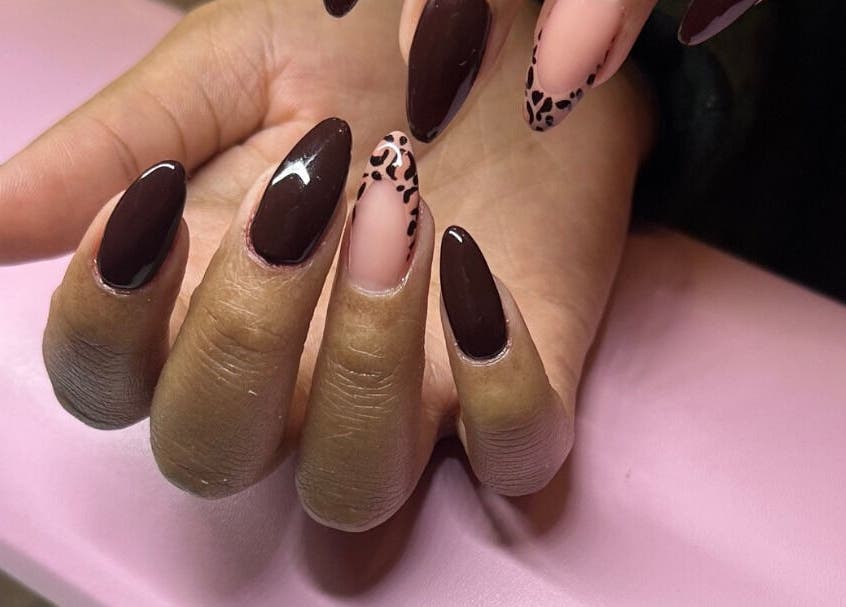 Stylish manicured hand with dark polish at Hunny's Clinique in Rustenburg, North West, ZA.