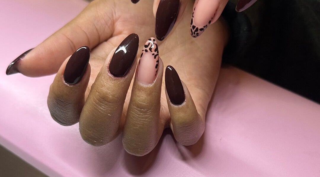 Stylish manicured hand with dark polish at Hunny's Clinique in Rustenburg, North West, ZA.