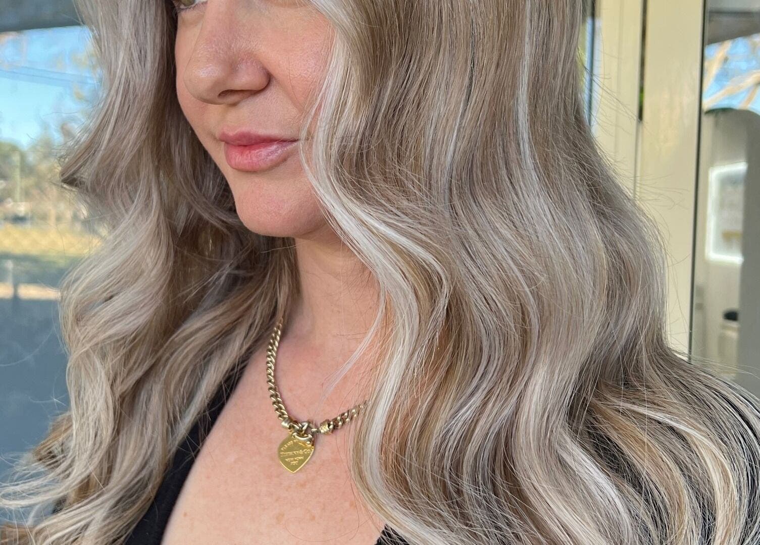 Elegant wavy blonde hairstyle at With an Edge Hair, Beauty and Head Spa Ormeau, Ormeau, Queensland, AU.