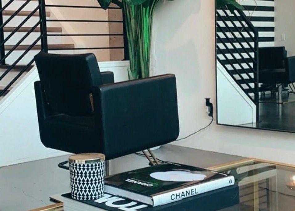 Stylish interior at Crimson & Clovis, Calgary, Alberta, CA with modern chair and decorative mirror.