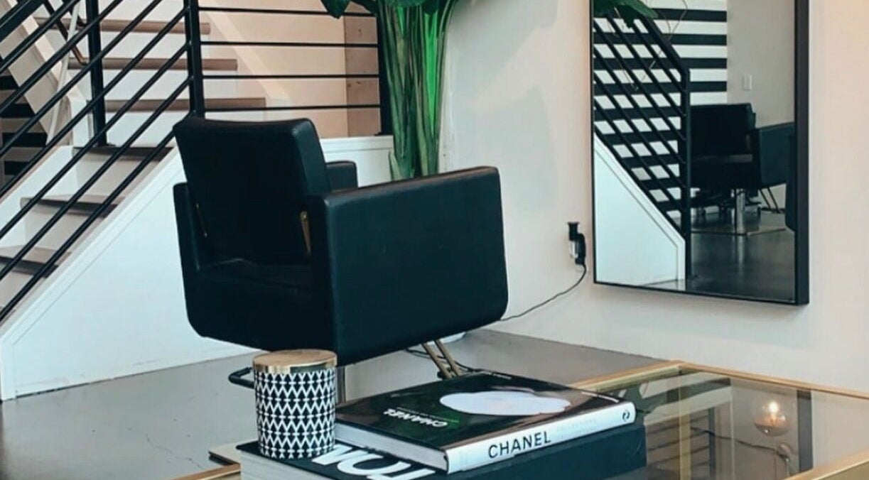 Stylish interior at Crimson & Clovis, Calgary, Alberta, CA with modern chair and decorative mirror.