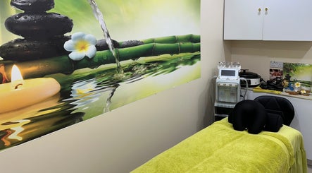 Relaxing spa room at Hydro Facial & Spa, London, England, GB with calming decor and massage table.