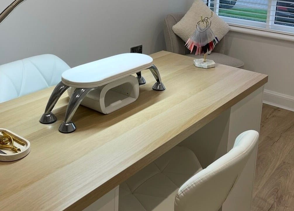 Elegant nail station at Nails by Alexandrea, Bonnyrigg, Scotland, GB with tools and a plush white chair.