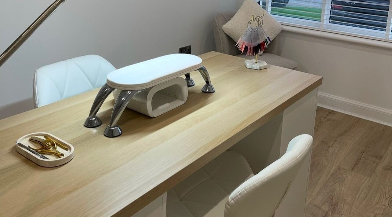 Elegant nail station at Nails by Alexandrea, Bonnyrigg, Scotland, GB with tools and a plush white chair.