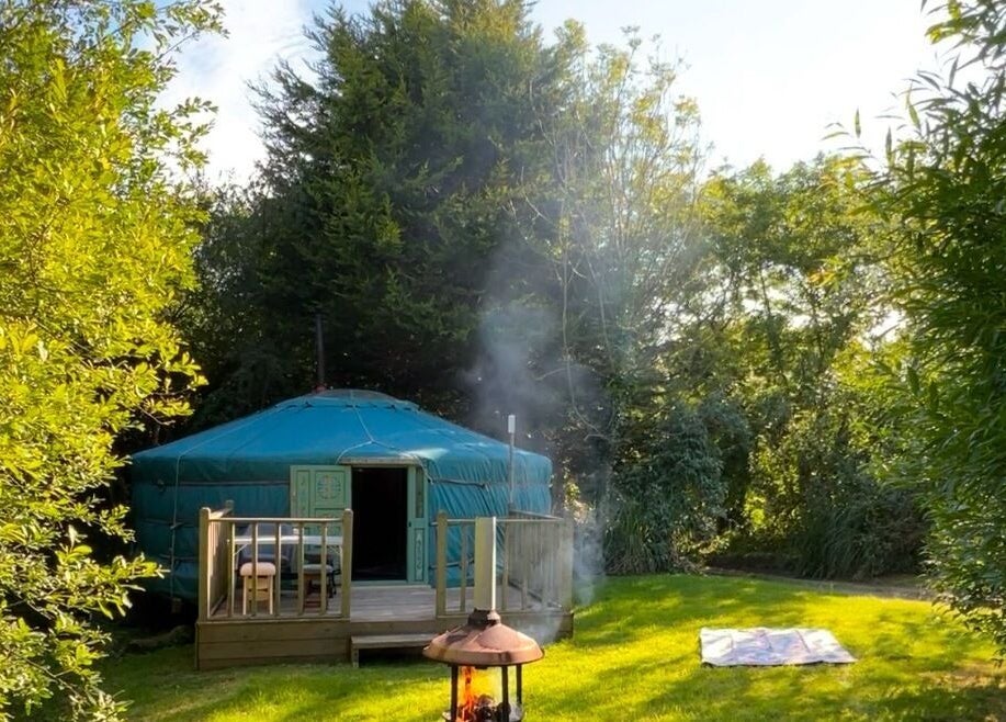 Cozy yurt at Wellness in the Wild, Newquay, England, GB, surrounded by lush greenery.