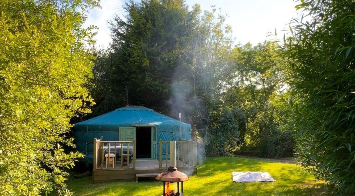 Cozy yurt at Wellness in the Wild, Newquay, England, GB, surrounded by lush greenery.