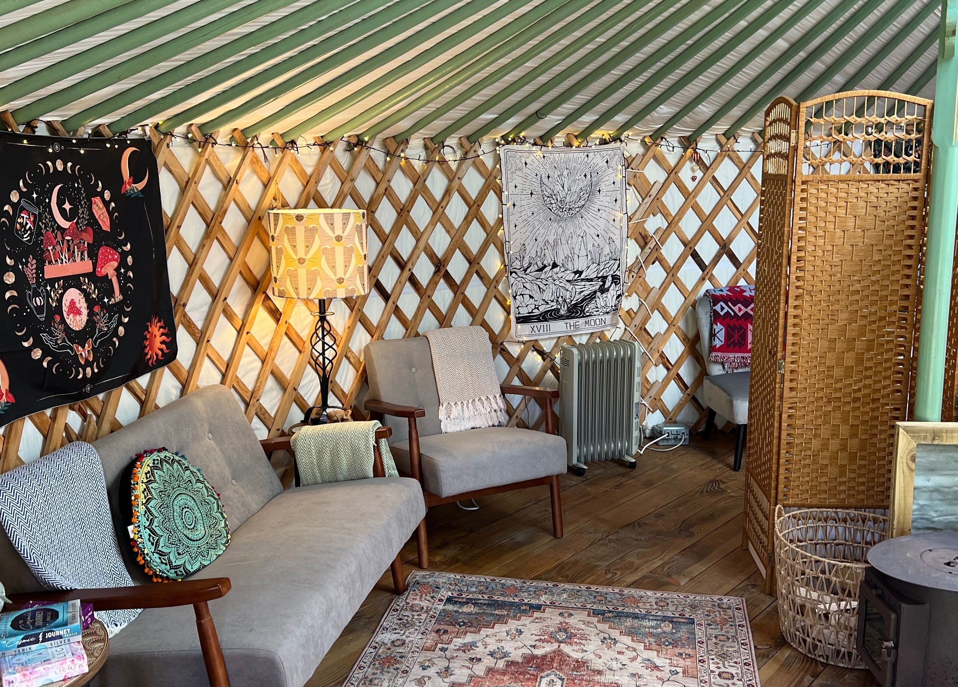 Relaxing yurt interior at Wellness in the Wild, Newquay, England, GB with comfy chairs and decor.
