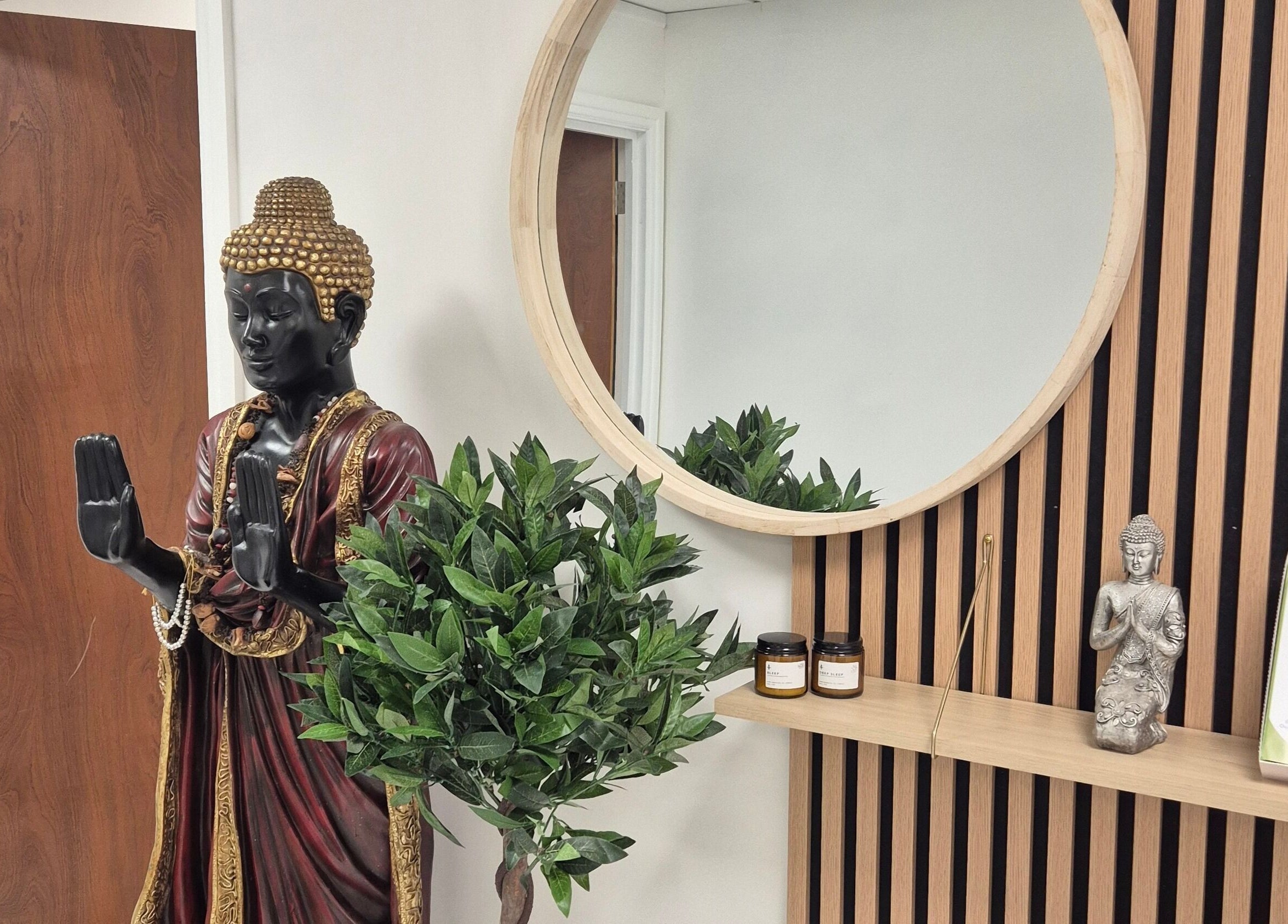 Peaceful Buddha statue and lush greenery at Louise Morgan Holistic Therapist in Bristol, England, GB.