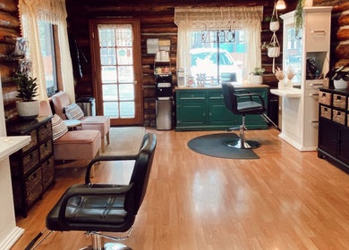Cozy interior of Emerald Grove Salon in South Lake Tahoe, California, US, featuring elegant chairs and decor.