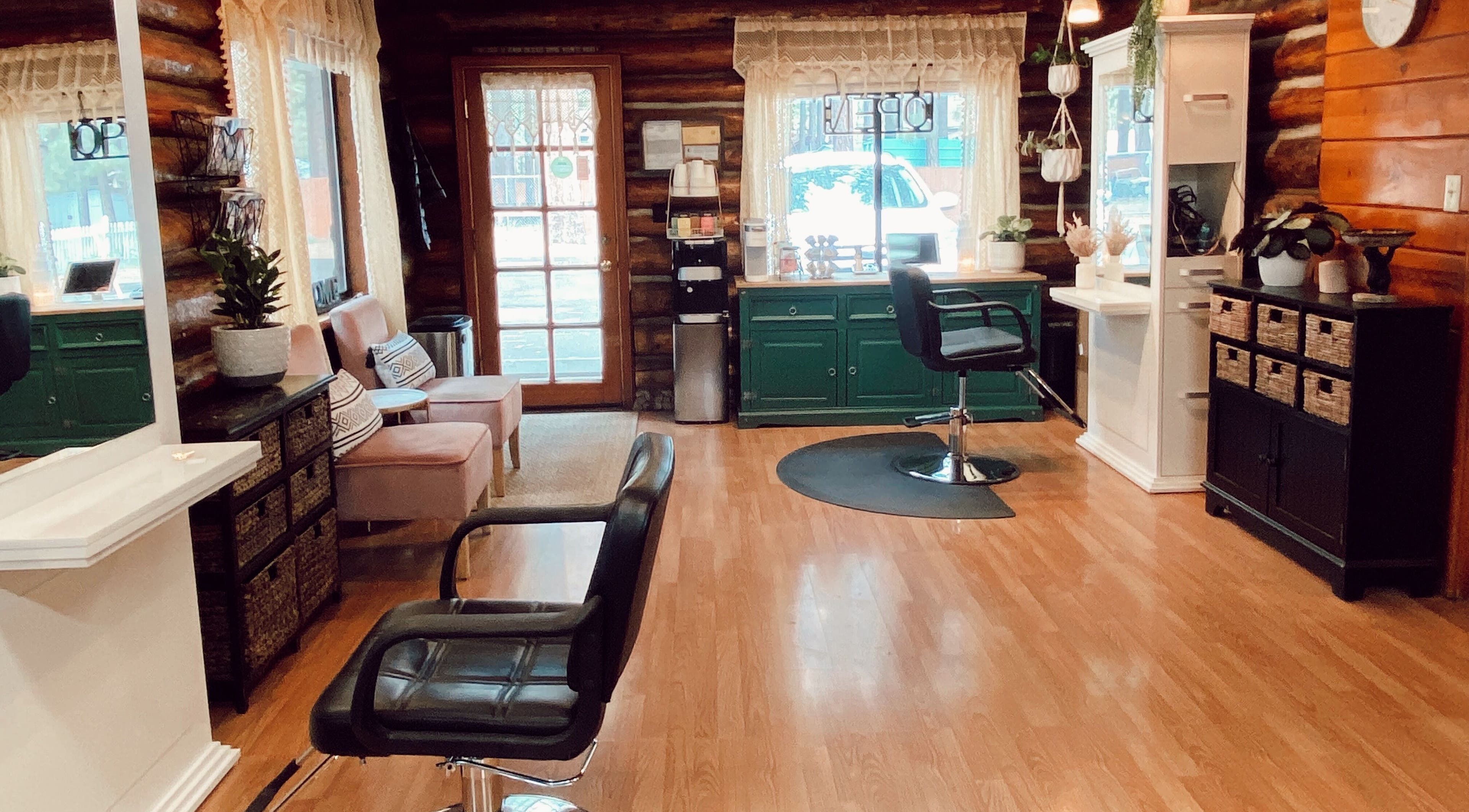 Cozy interior of Emerald Grove Salon in South Lake Tahoe, California, US, featuring elegant chairs and decor.