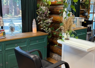 Stylish corner at Emerald Grove Salon in South Lake Tahoe, California, featuring chic decor and natural light.
