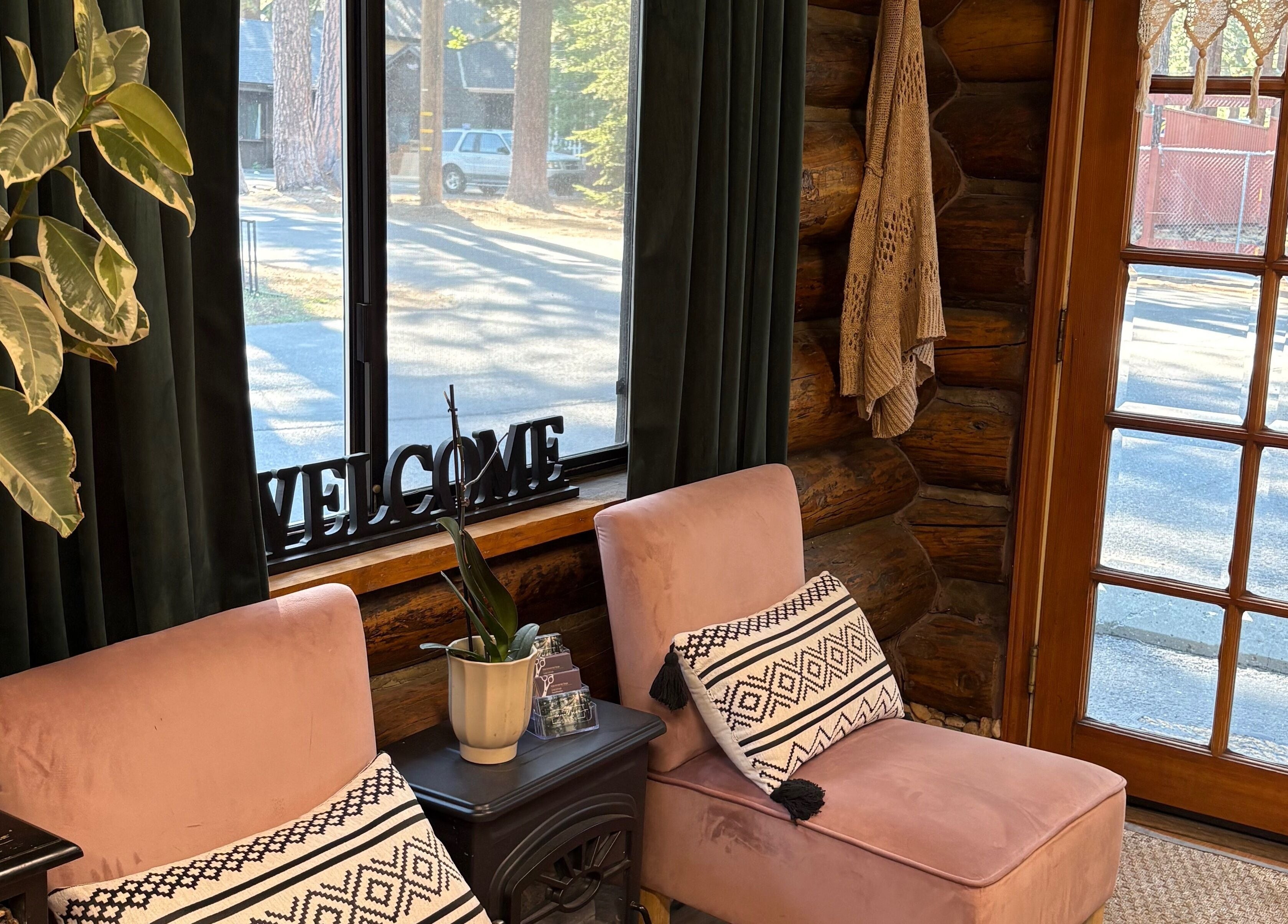 Inviting seating area at Emerald Grove Salon in South Lake Tahoe, California, US with modern decor and lush plants.