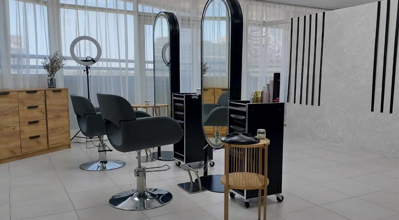 Modern styling area at Babochka Ladies Salon, Dubai, AE with sleek chairs and mirrors.