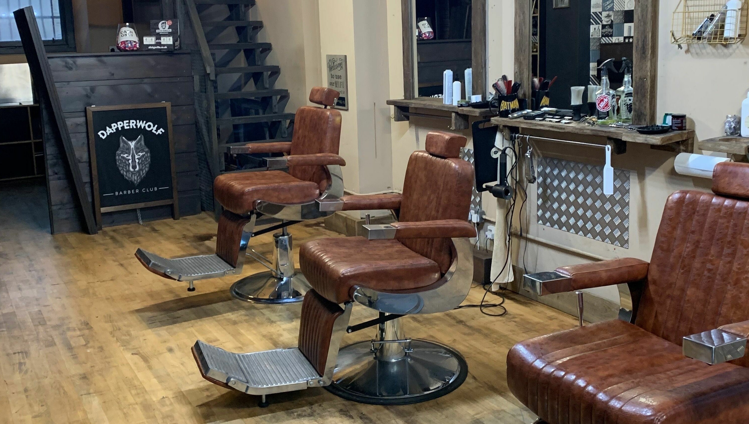 Classic barber chairs at Dapperwolf, a stylish barbershop in Glasgow, Scotland, GB.