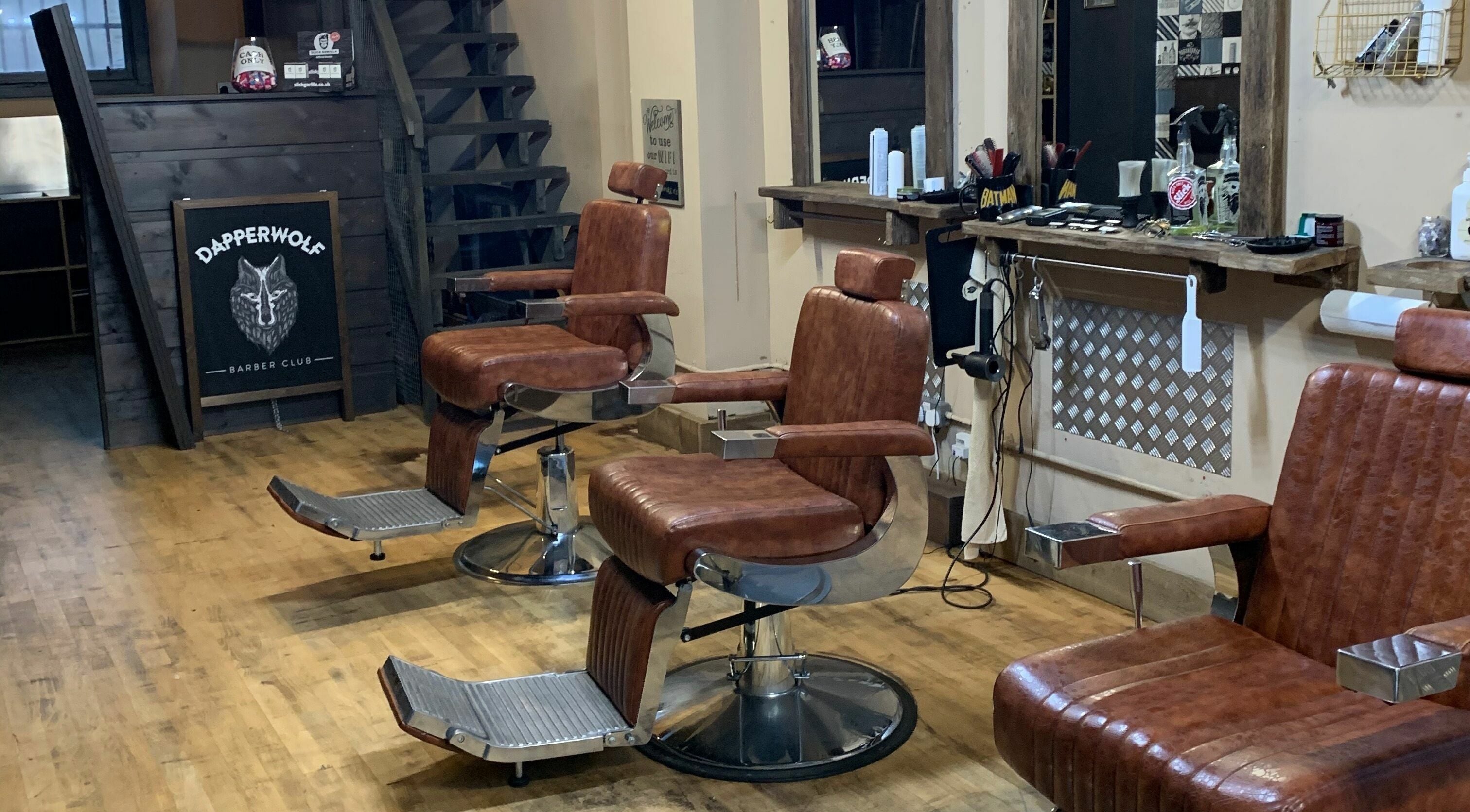 Classic barber chairs at Dapperwolf, a stylish barbershop in Glasgow, Scotland, GB.