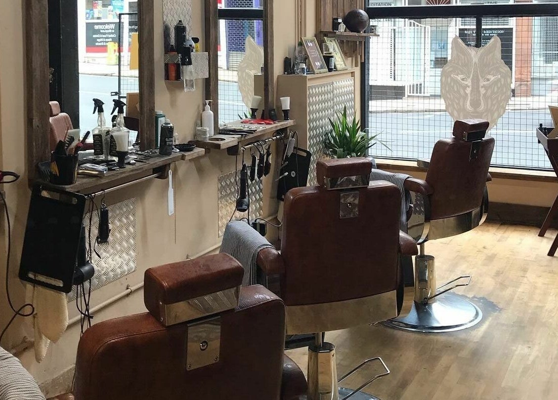 Chic barber chairs at Dapperwolf, Glasgow, Scotland, GB showcasing a modern beauty setting.