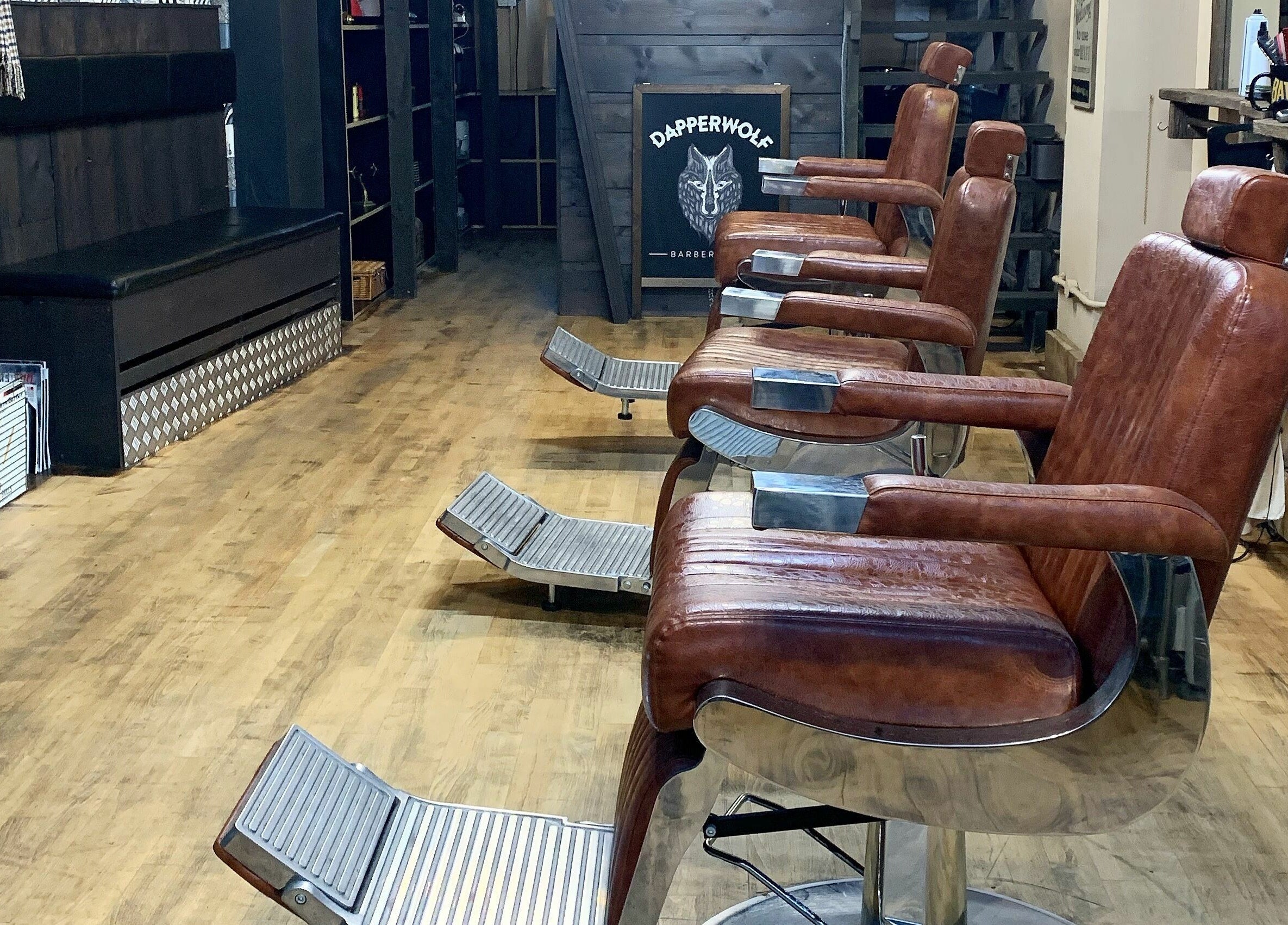 Vintage-style leather chairs at Dapperwolf, Glasgow, Scotland, GB, showcasing a classy barber setup.