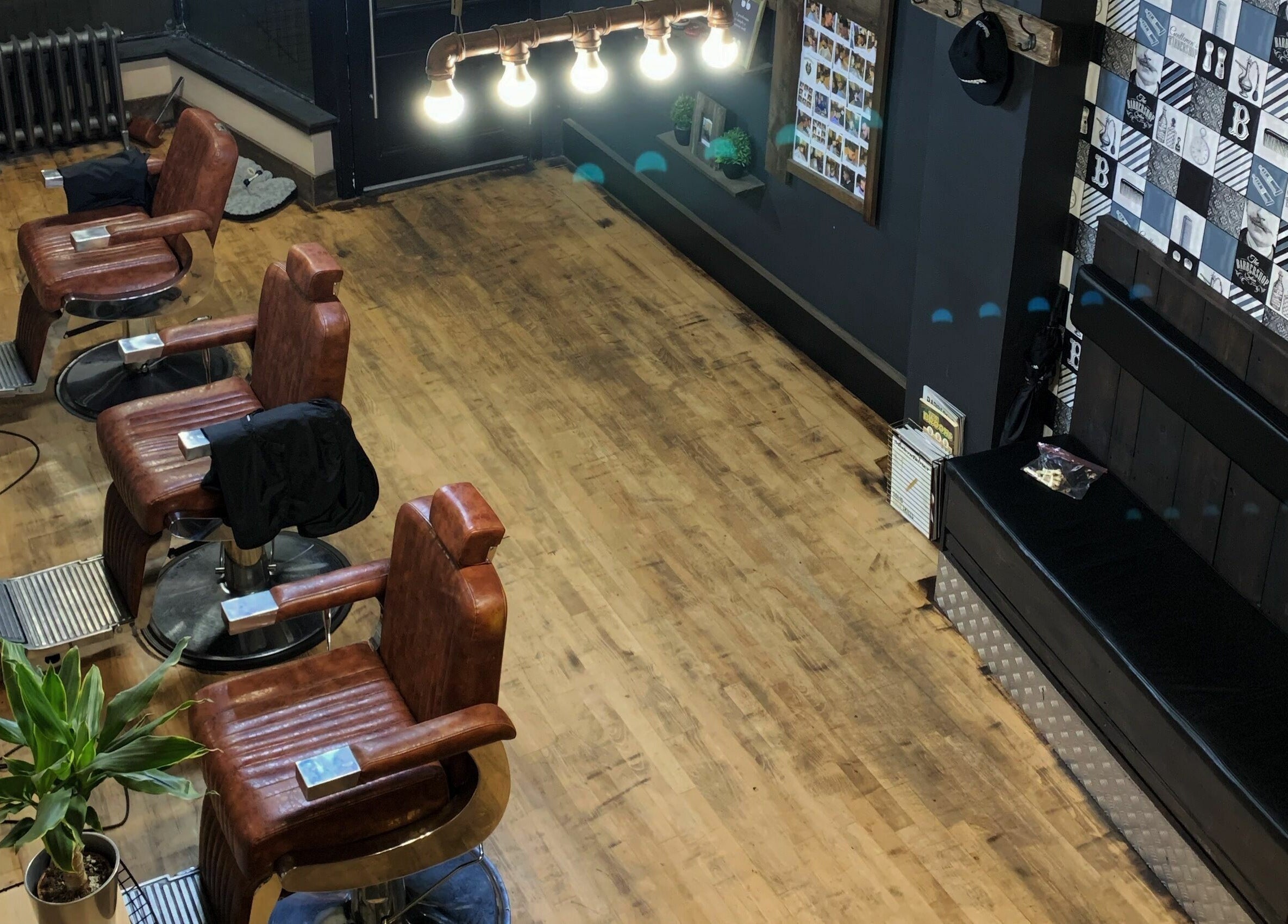 Rustic barber chairs at Dapperwolf, Glasgow, Scotland, GB showcase modern elegance and comfort.