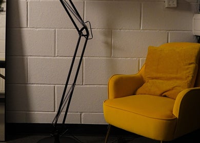 Modern yellow chair with cushion at Grounded Performance, Livingston, Scotland, GB.
